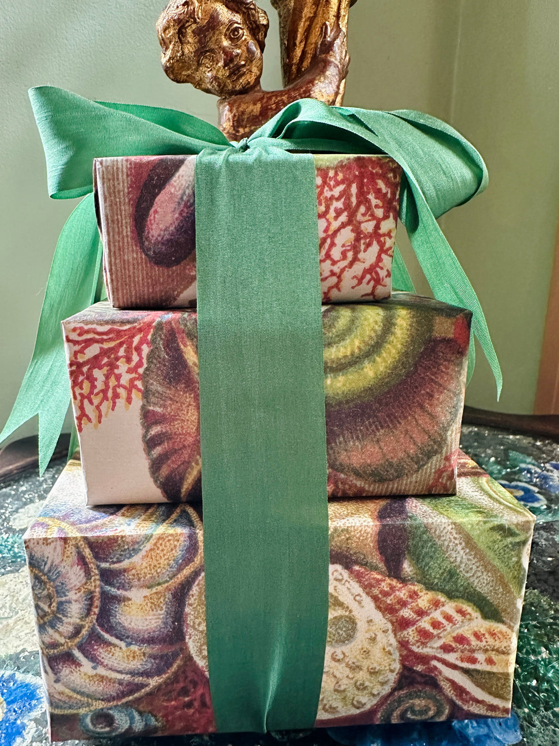 Stack of gorgeous gifts wrapped with unique paper from Caldwell's