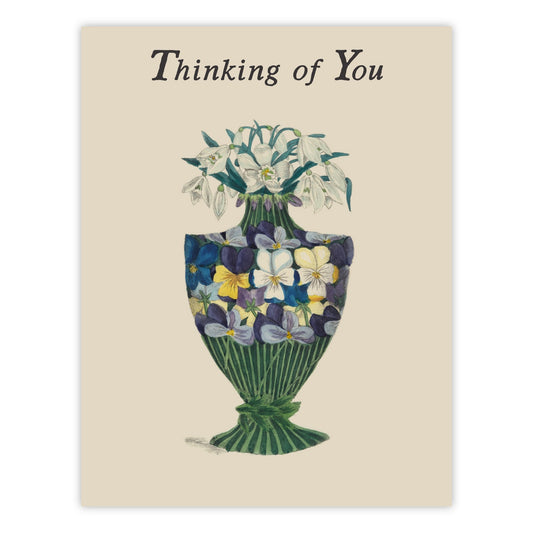 Vintage-style Thinking of You greeting card featuring a hand colored pansy and snowdrop bouquet in an allegorical vase, on cream cardstock.
