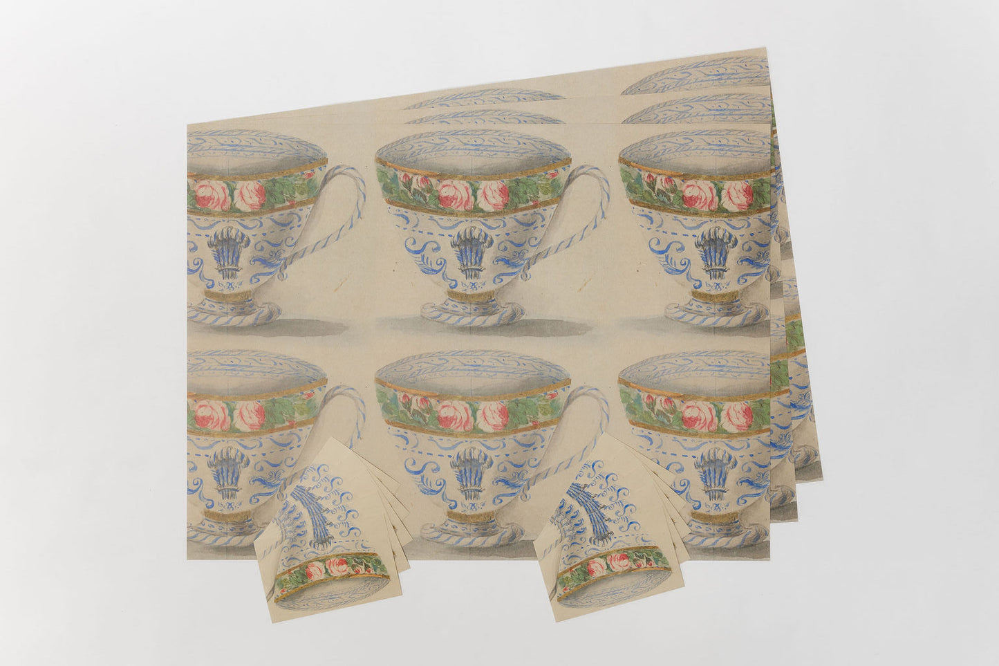 Pack of gift wrap and postcardswith floral and teacup design on a white background