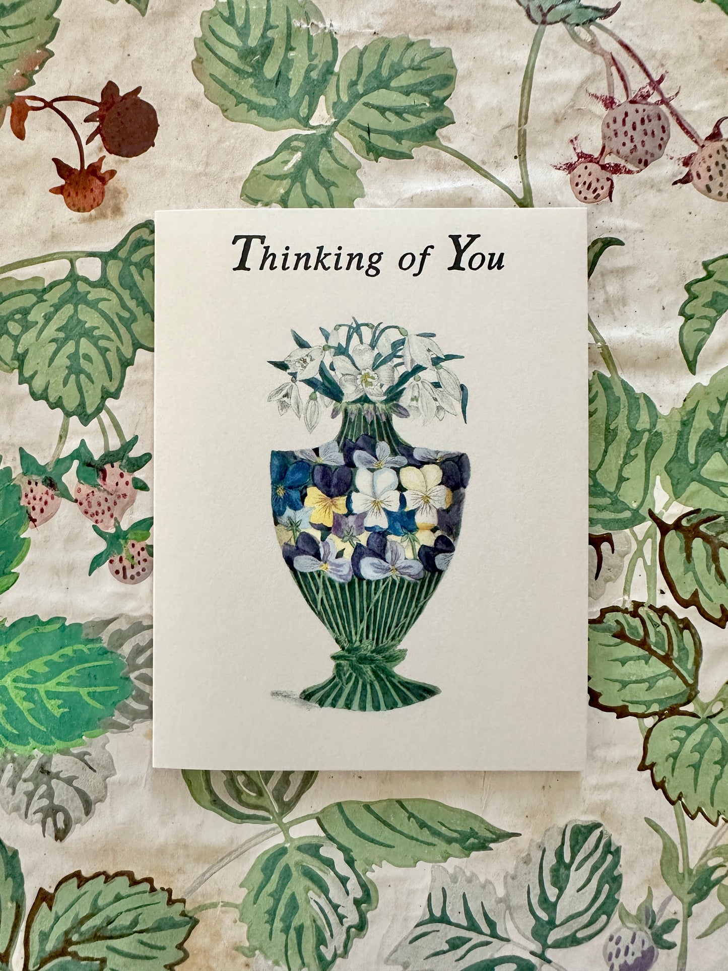 Thinking of You Pansy Vase card with pansy and snowdrop illustration displayed against a coordinating antique floral backdrop, by Caldwell's Miscellaneous Fancy Goods.