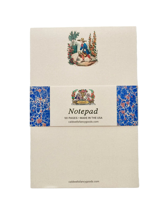 Vintage-style notepad featuring a young gardener in period dress with two watering cans and a wide-brimmed straw hat, tending hollyhocks, roses, and a tree in a French planter, on cream paper. There is an informational belly band around the center of the notepad.
