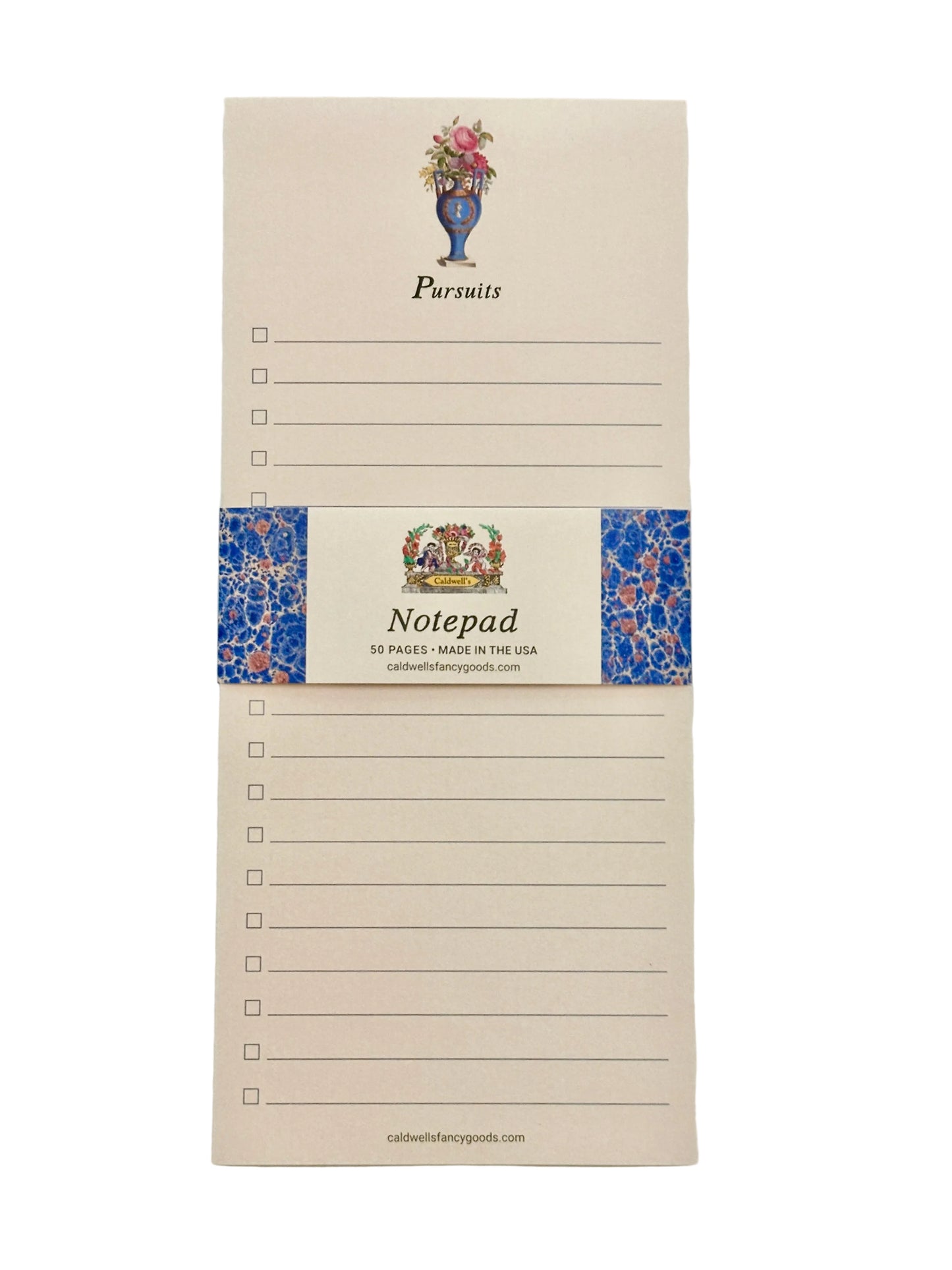 A cream-colored notepad with a blue floral patterned band around the center, featuring the word 'Pursuits' at the top and 'Notepad' on the band, photographed against a light neutral background.